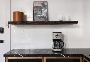 a coffee maker on a counter with a shelf at 1BR Escape Queen Bed WiFi & Kitchenette in San Diego