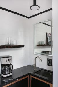 a kitchen counter with a sink and a mirror at 1BR Escape Queen Bed WiFi & Kitchenette in San Diego +19 photos
