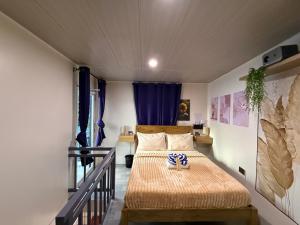 a bedroom with a bed with a blue curtain at Alf's Guesthouse in Panglao Island +51 photos