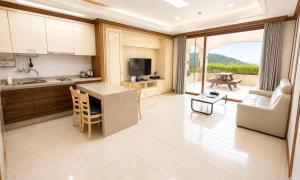 a kitchen and living room with a couch and a table at Seosansoo Golf & Resort in Seosan