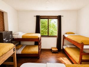 a room with four bunk beds and a window at Hostal Licanantay in Valparaíso