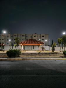a building with a gazebo in front of it at night at Departamento cercano AIFA in Santa Cruz Tecamac +3 photos