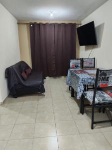 a living room with a table and a chair at Departamento cercano AIFA in Santa Cruz Tecamac