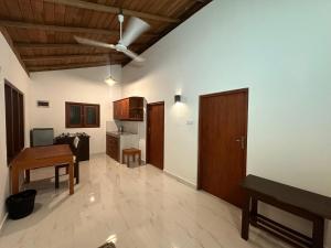 a living room with a table and a kitchen at Body,Mind & Soul in Bentota