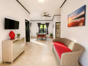 a living room with a couch and a tv at Bugbug Beach Resort in Gili Biaha