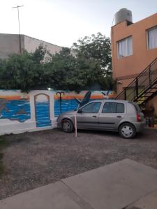 a car parked in a parking lot next to a wall at Dpto playa in Las Grutas