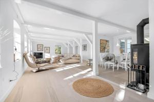 a living room with white furniture and a fireplace at 3331-Stege-Raby-Sovej-1 in Stege