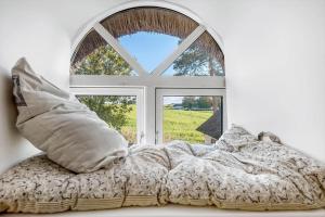 a bedroom with a bed and a window at 3331-Stege-Raby-Sovej-1 in Stege