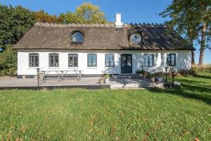 a white house with a bench in front of it at 3331-Stege-Raby-Sovej-1 in Stege