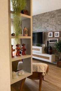a living room with a tv and a shelf at Luxury flat in Monte Castelo in Sairé