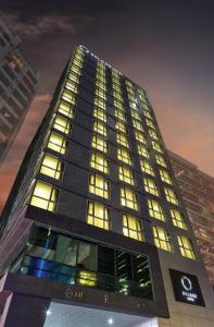 a tall building with many windows at night at Ocloud Hotel Gangnam in Seoul
