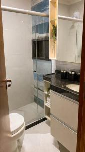 a bathroom with a toilet and a glass shower at Luxury flat in Monte Castelo in Sairé +18 photos