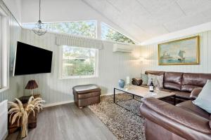 a living room with a couch and a table at S742-Stroby-Garderhojen-32 in Strøby