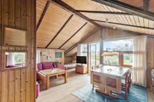 a living room with a table and a couch at R971-Rodvig-Stuven-65 in Rødvig +12 photos