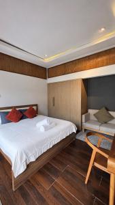 a bedroom with a large bed and a wooden floor at Sutji living in Sanur +31 photos
