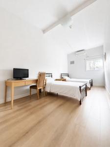 a bedroom with two beds and a desk and a desk at Box Hill Student Accommodation and Rooming House in Box Hill