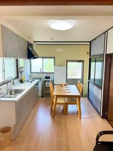a kitchen and dining room with a table and chairs at 一棟貸切民宿Saisai 3部屋 in Sakai