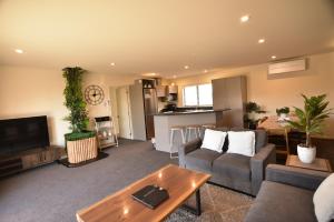 a living room with a couch and a table at Twin Stars in Lake Tekapo