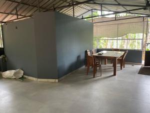 a dining room with a table and chairs at CHRIS COZY FARM cottage in Wayanad