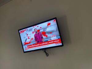 a flat screen tv hanging on a wall at CHRIS COZY FARM cottage in Wayanad