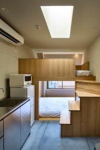 a small kitchen with a bed in a room at Hotel Matoma 別館 in Tokyo