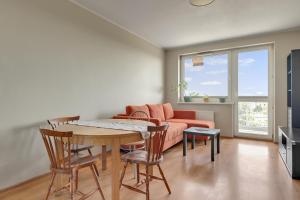 a living room with a table and a couch at Słoneczny Widok in Gdynia