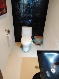 a bathroom with a toilet and a sink at Rosa Executive Residence in heart of Ormoc City in Ormoc +27 photos