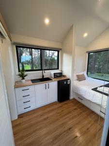 a tiny house with a kitchen and a bed at BIG4 Sale Caravan Park in Sale