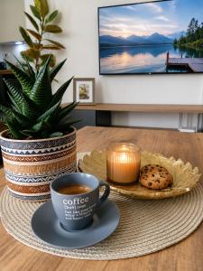 a cup of coffee and cookies on a table at SOLU Luxury Apartments with Free Parking ,Fast Wi -Fi, New Building in Skopje