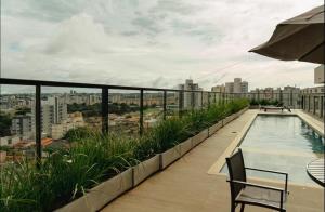 a balcony with a swimming pool on top of a building at Studio próximo a UFU Sta Monica e Center shopping in Uberlândia