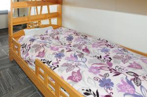 Voodi või voodid majutusasutuse Sakura Guest House toas