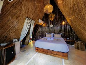 a bedroom with a large bed in a attic at Delta Casa Ubud - A-Frame Jungle Retreat with Volcano View and Hot-Tubs in Gianyar