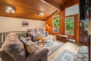 a living room with a couch and a table at Limber Pine Townhome and 2BDR Stay in Whitefish
