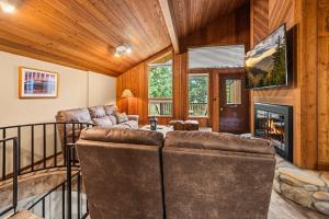 a living room with a couch and a fireplace at Limber Pine Townhome and 2BDR Stay in Whitefish