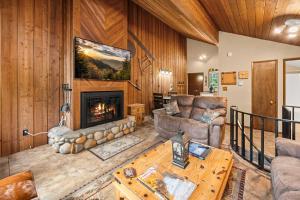 a living room with a couch and a fireplace at Limber Pine Townhome and 2BDR Stay in Whitefish +19 photos
