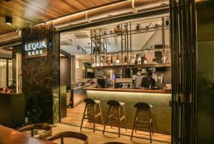 a restaurant with a bar with stools around it at Mood Hotel in Skudai