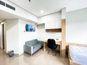 a bedroom with a desk and a bed and a chair at Prime UMY Hotel Convention & Dormitory in Yogyakarta