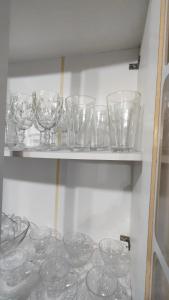 a bunch of glass bowls on a shelf at Propriedade Mendes&Souza - Pinhais in Pinhais +34 photos
