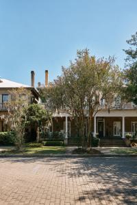 a large house with a brick driveway in front of it at Downtown Savannah Oasis in Savannah