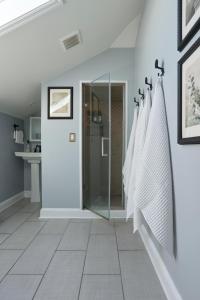 a bathroom with white walls and a glass shower stall at Downtown Savannah Oasis in Savannah +45 photos