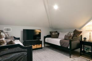 a bedroom with a bed and a tv and a couch at Downtown Savannah Oasis in Savannah