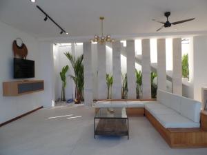 a living room with a couch and a table at The Siren Resort Nusa Penida - Ocean View Villas in Nusa Penida
