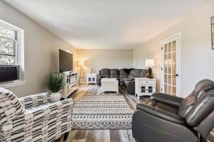 a living room with two couches and a tv at Spacious Colonial Large Groups Fire Pit in Brewer
