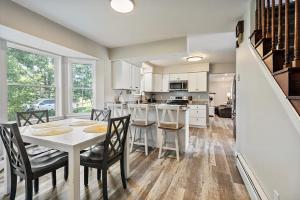 a kitchen and dining room with a table and chairs at Spacious Colonial Large Groups Fire Pit in Brewer