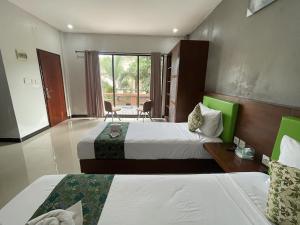 a hotel room with two beds and a balcony at Melati Kuta Lombok in Kuta Lombok +30 photos