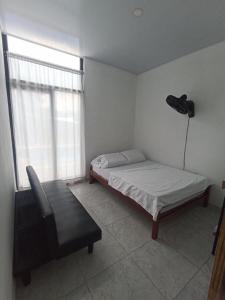 a bedroom with a bed and a chair and a window at Maná Quinta Campestre in Carmen de Apicalá +20 photos