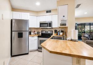 a kitchen with white cabinets and a stainless steel refrigerator at 3608 Orlando Vacational 1st floor in Orlando