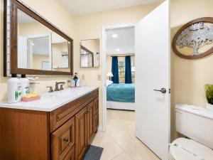 a bathroom with a sink and a mirror at 3608 Orlando Vacational 1st floor in Orlando +54 photos