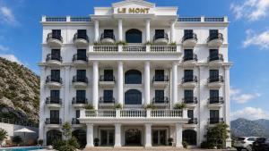 a white building with a sign on it at Le Mont Yên Bái in Yên Bái