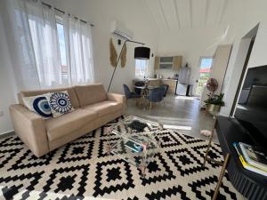a living room with a couch and a table at Serene Shores, Punta Azul, Westpunt in Westpunt